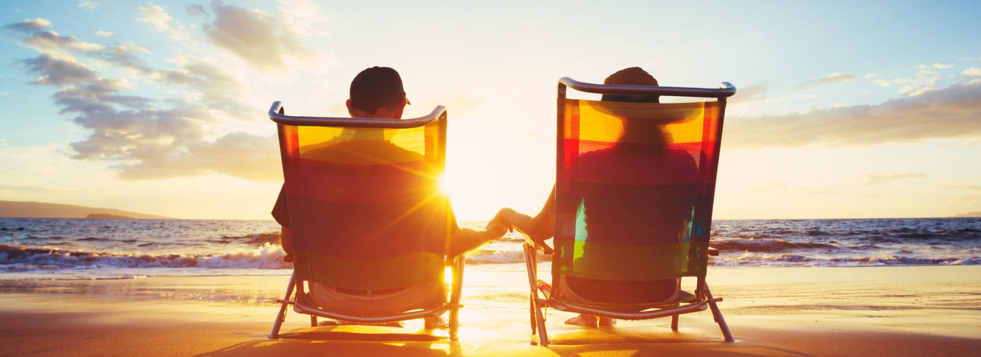 couple sitting on the beach| sarasota real estate florida